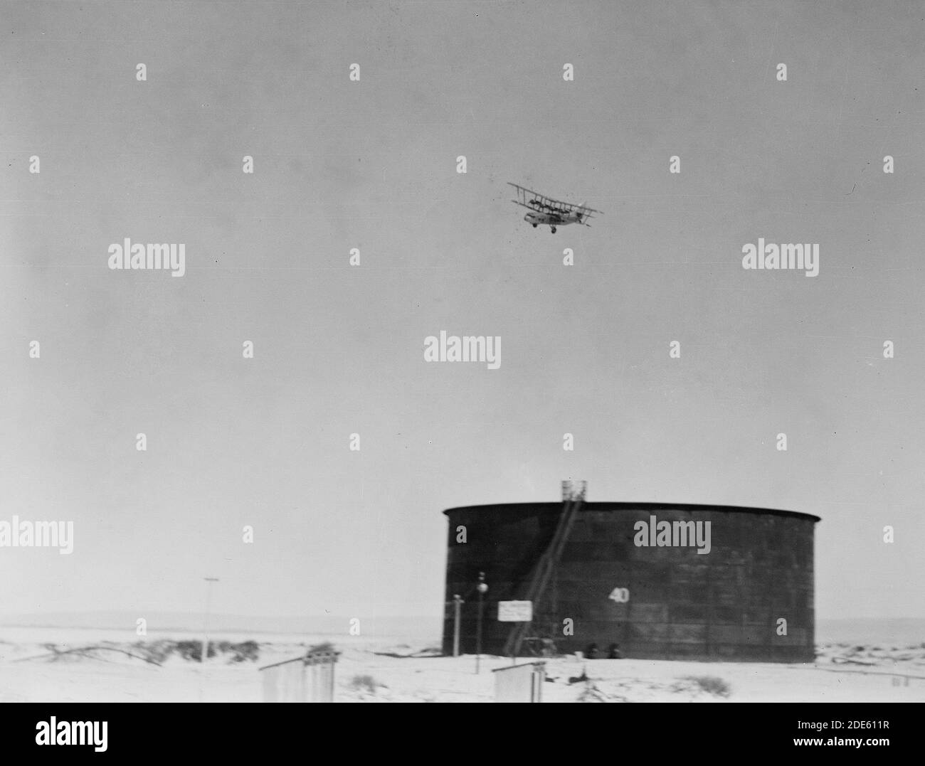 Original Caption:  I.P.C. [i.e. Iraq Petroleum Company]. Tank at Haifa terminus with plane in sky  - Location: Israel--Haifa ca.  1934-1939 Stock Photo