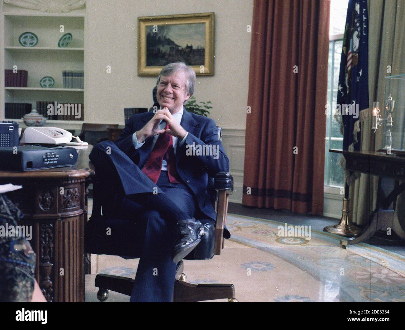 Jimmy Carter at his desk in the Oval Office ca. 13 December 1977 Stock