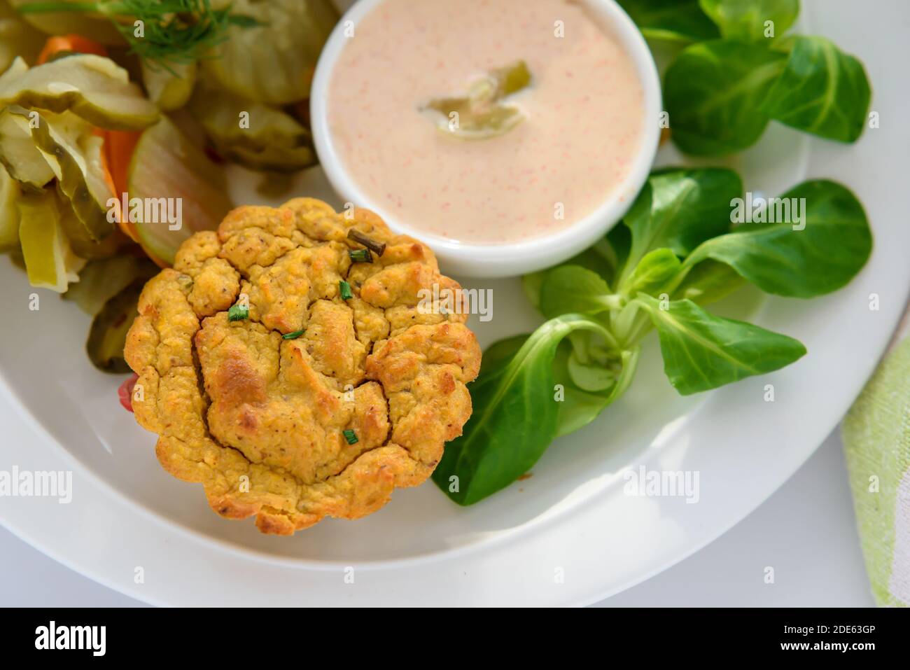 Vegan vegetable muffins with light chili-mayo dip and cucumber pickle salad, close-up, lamb's lettuce Stock Photo