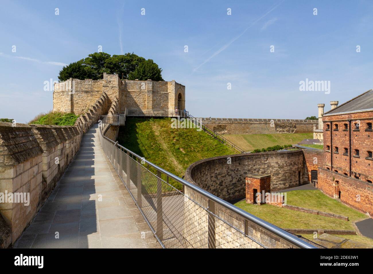View along part of the Medieval Wall Walk towards Lucy Tower,  Lincoln Castle, Lincoln, Lincs, UK. Victorian Prison on the right. Stock Photo