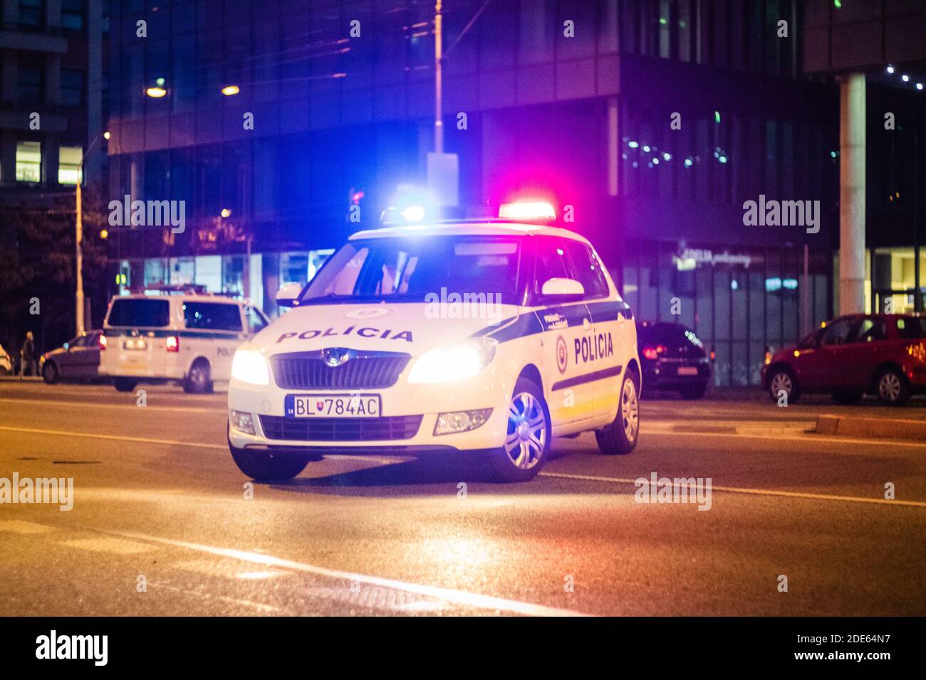 Slovak police car with lights turned on blocking the road on anti-governmental protest against corona restrictions at night Stock Photo