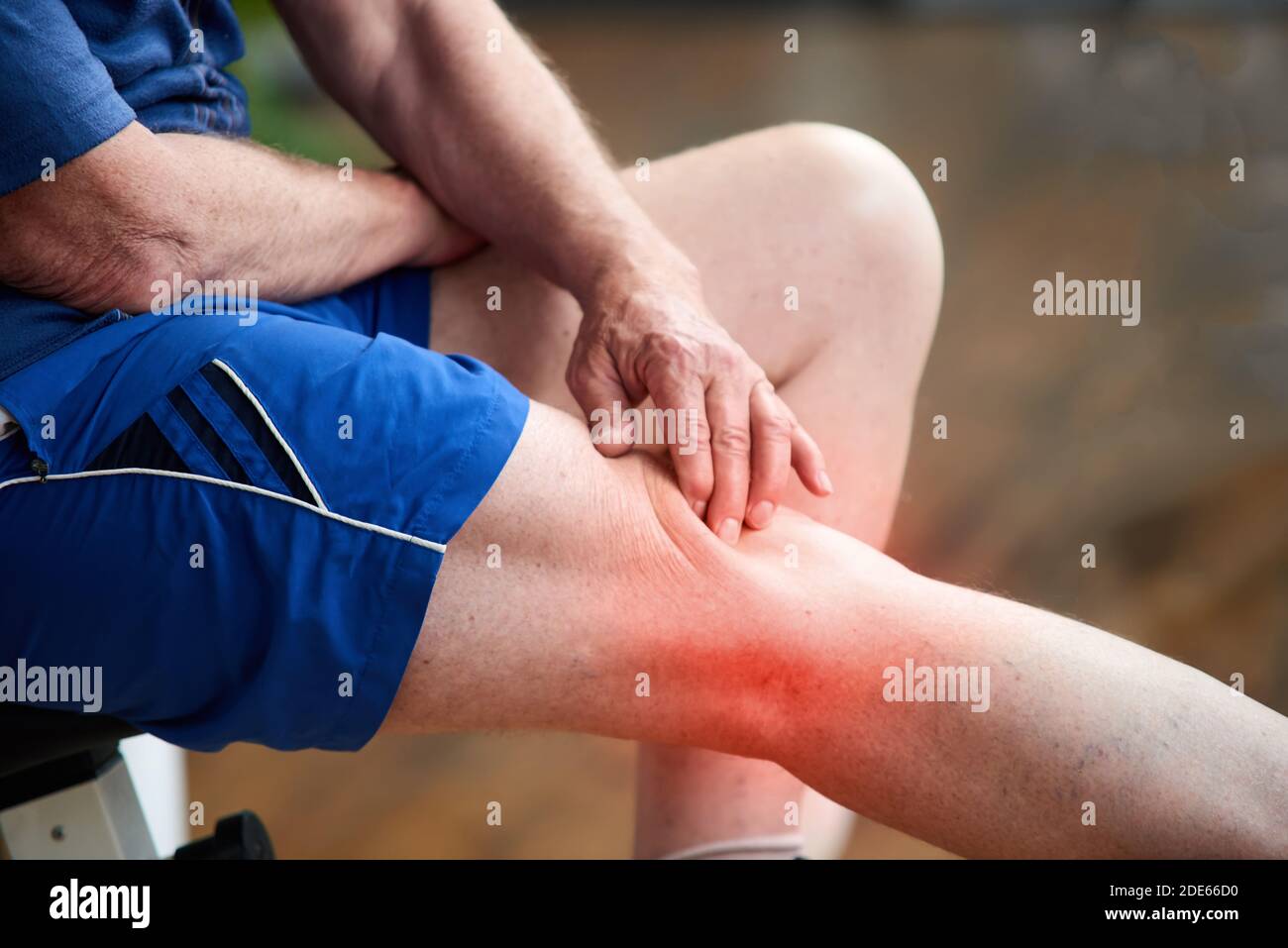 Unrecognizable elderly man having knee pain. Stock Photo