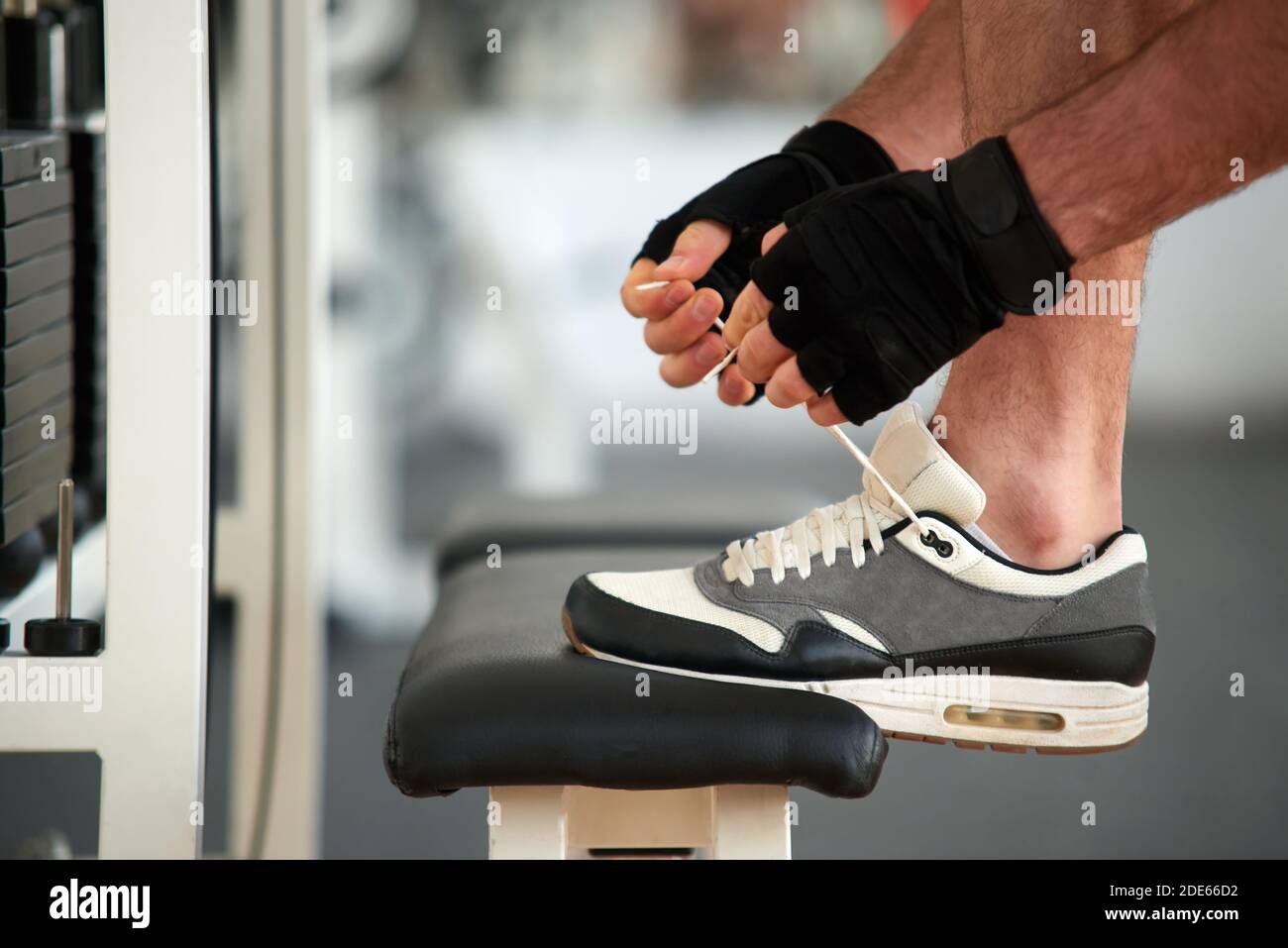 View of Man tying sport shoes before workout at gym Stock Photo - Alamy