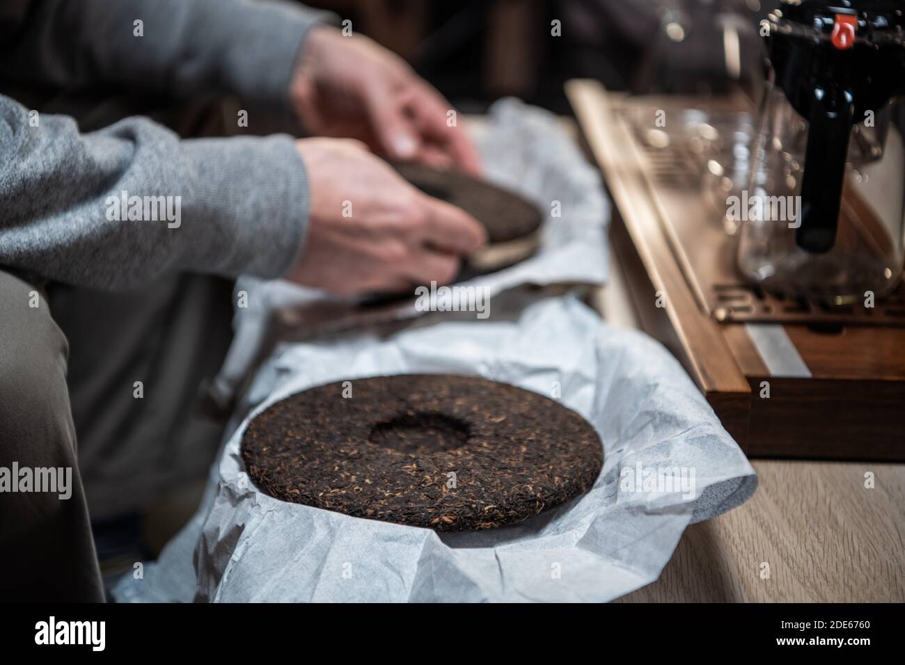 A Piece Of Raw Pu Erh Tea Cake In The Hands Of A Tea Master Before A Real Chinese Tea Ceremony In A Tea House Stock Photo Alamy