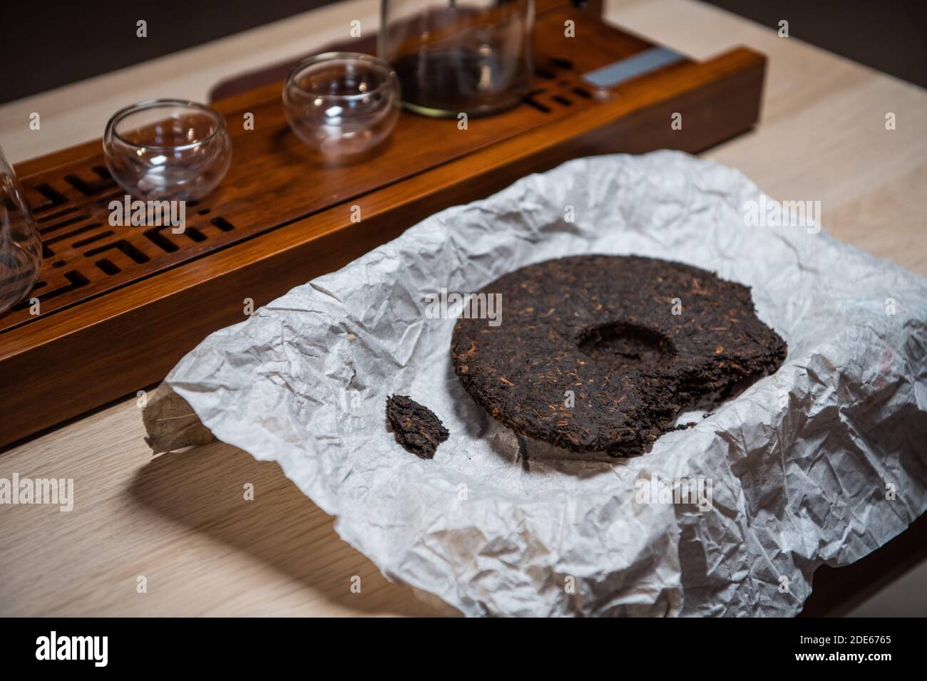 Close Up Of A Tea Cake Of Real Eastern Pu Erh Tea On The Table In A Paper Wrapper Stock Photo Alamy