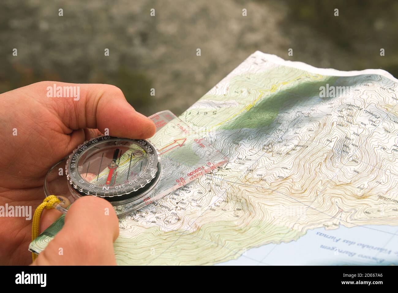 Explorer orienteering with compass and topographic map Stock Photo