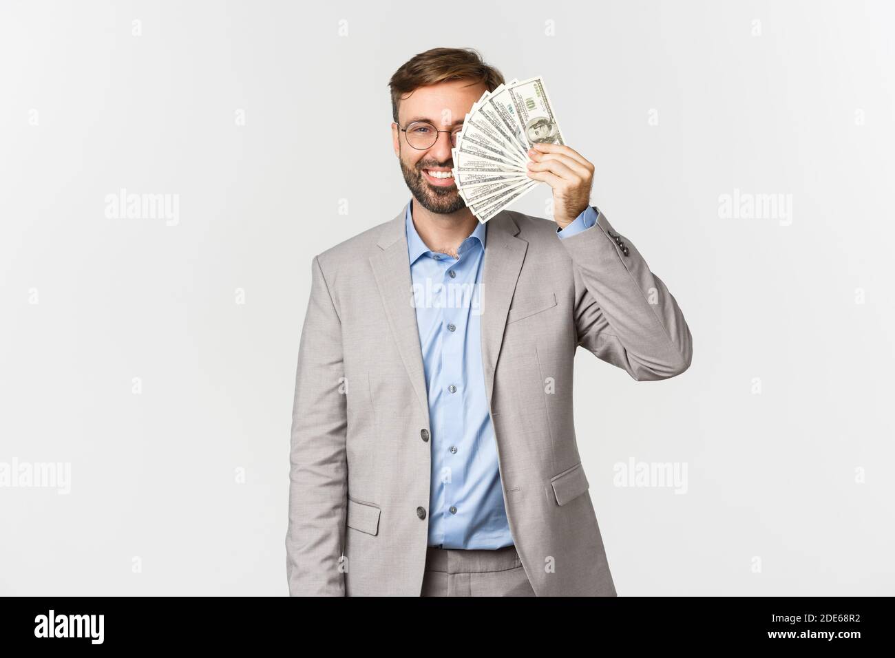 Image of successful businessman in grey suit and glasses, showing money ...