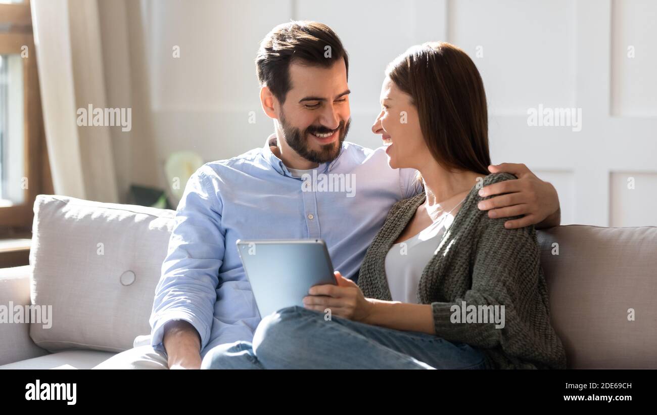 Happy young couple relax using tablet at home Stock Photo