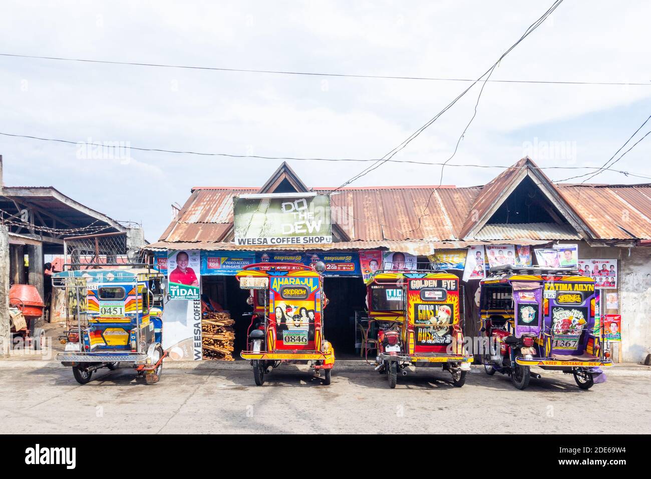 Tricycles, local passenger vehicles, parked at a roadside in Tawitawi, Philippines Stock Photo