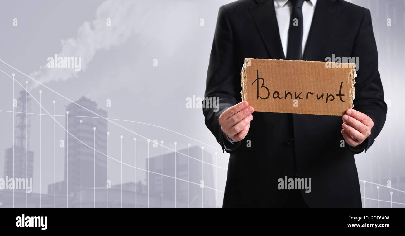 Business person showing cardboard with message Bankrupt of the plant Stock Photo