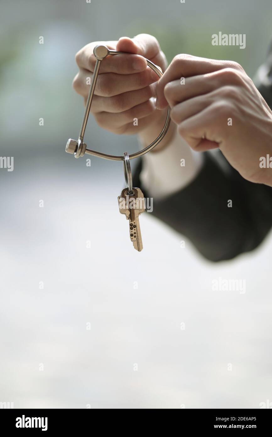 Businessman holding key ring and key Stock Photo