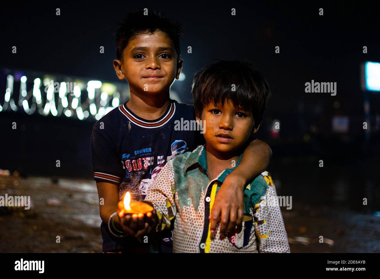 Barrackpore, West Bengal, India. 29th Nov, 2020. Two kids with an earthen lamp in their hand, enjoying the evening of Dev Deepawali at the bank of the river Ganga. Credit: Santarpan Roy/ZUMA Wire/Alamy Live News Stock Photo
