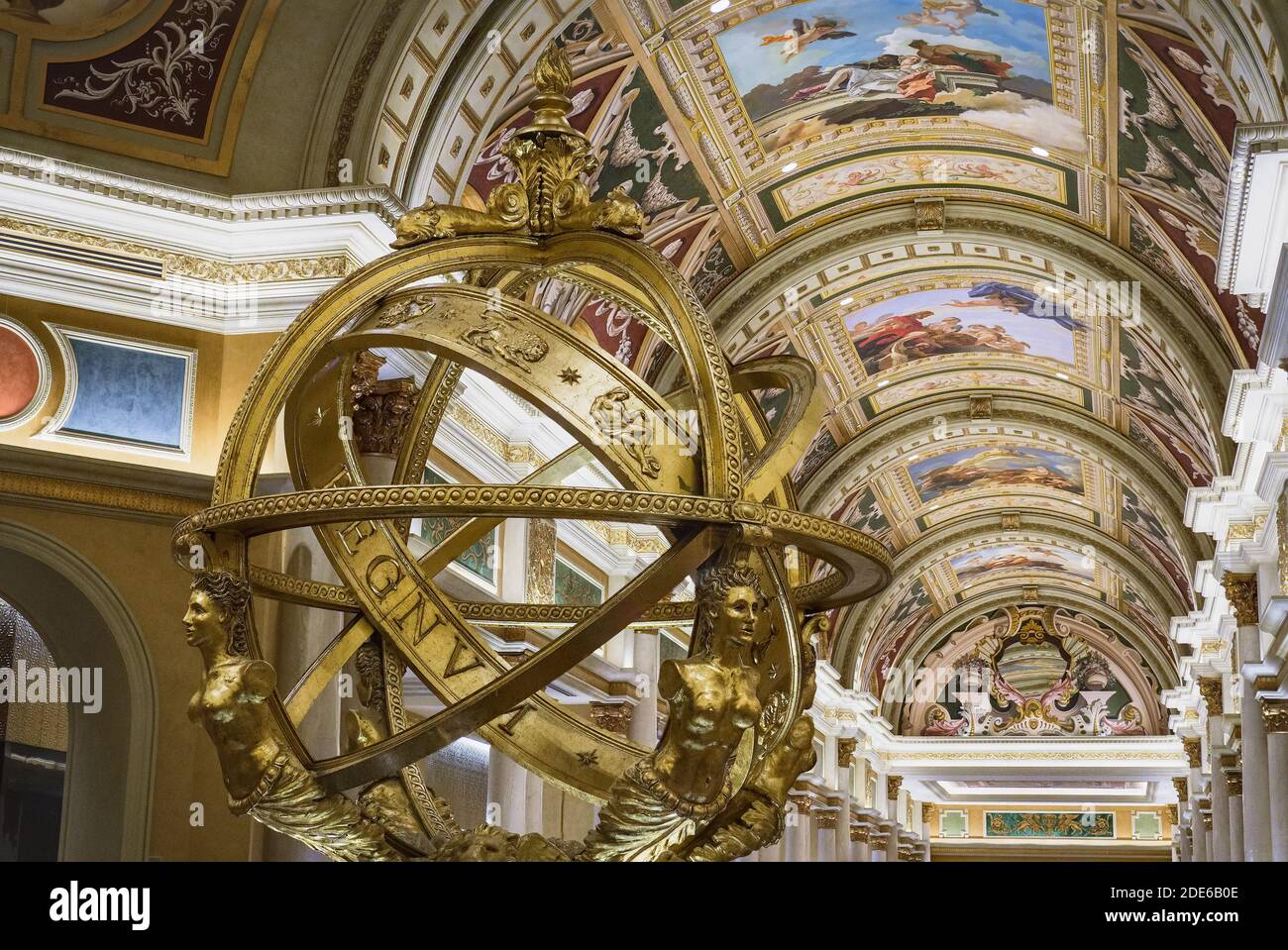 The spectacular golden armillary sphere and frescoed ceiling of The Venetian Hotel lobby connecting the reception area to the casino and shops, Las Ve Stock Photo