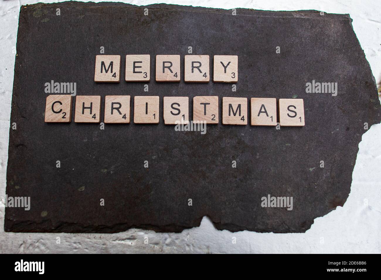Belfast UK, 29th November. The words Merry Christmas, written in Wooden tiles on a Slate base Credit Bonzo/Alamay Live news Stock Photo