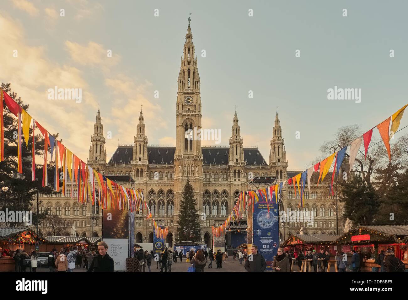 People socialising in the Christmas market stalls in front of the