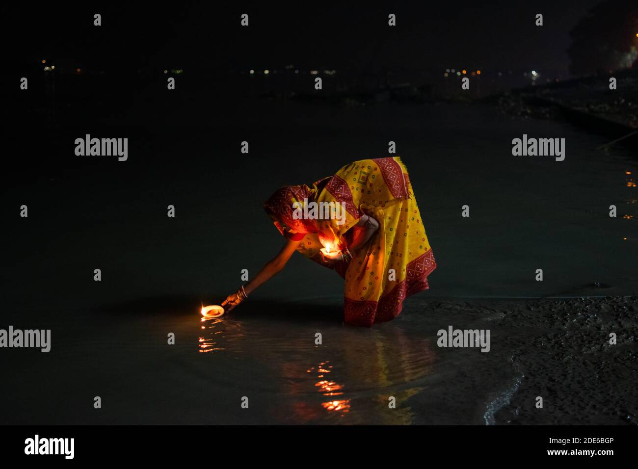 Barrackpore, West Bengal, India. 29th Nov, 2020. A woman is floating earthen laps into the holy river Ganga as a ritual of Dev Deepawali festival. Credit: Santarpan Roy/ZUMA Wire/Alamy Live News Stock Photo