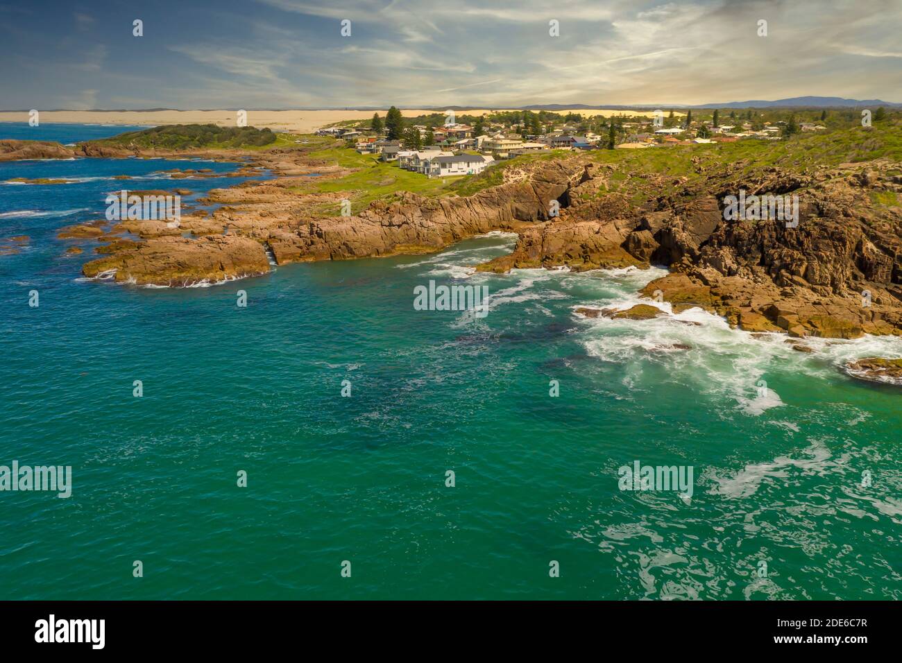 Aerial view of the Stockton Sand Dunes and blue water of the Tasman Sea at Birubi Point near