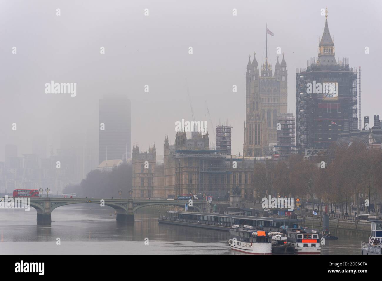 Foggy morning in London. Palace of Westminster, Parliament, on a grim, dull day. Elizabeth Tower, Big Ben, shrouded in scaffolding for renovation Stock Photo