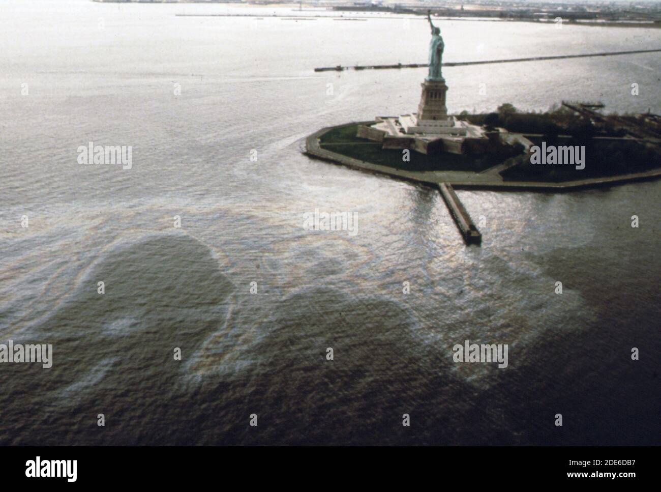 Oil slick surrounds the Statue of Liberty in New York Harbor ca. 1973
