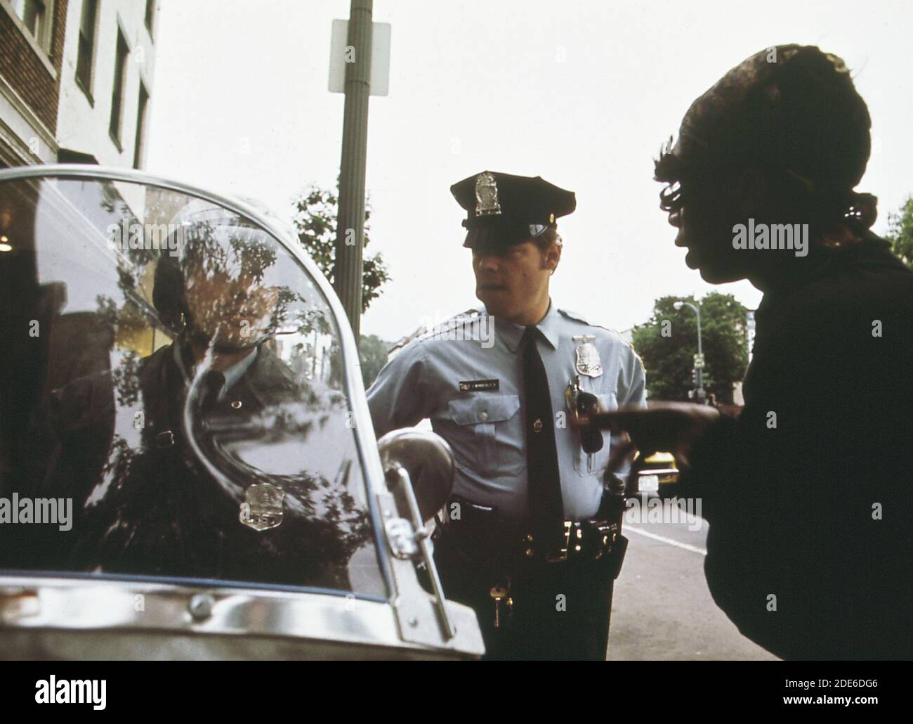 Police Officer calls paddy wagon for disturber of the peace (Washington D.C.)   ca. 1973 Stock Photo