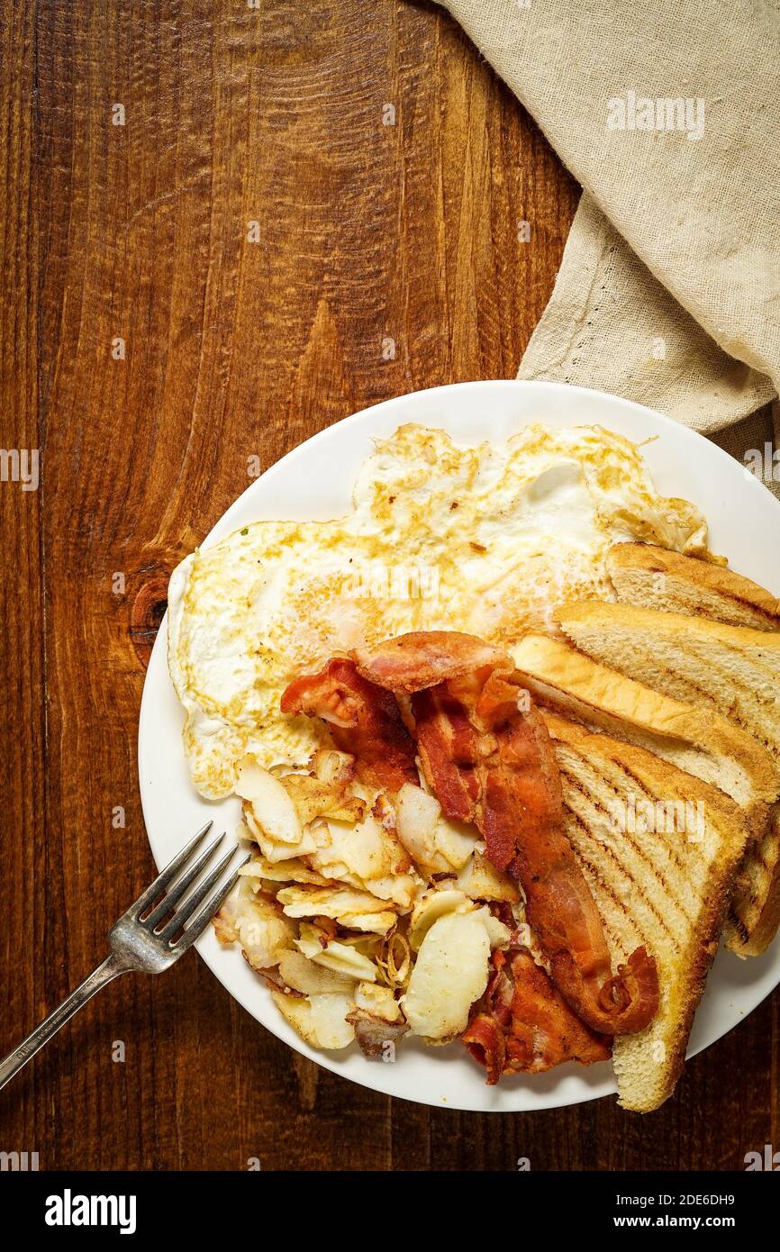 Bacon, eggs, potatoes and toast Stock Photo
