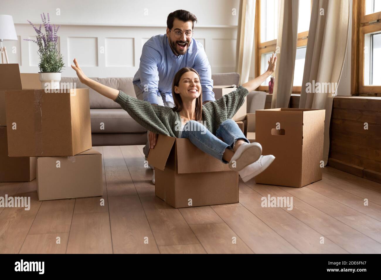 Happy coupler ride in boxes have fun on moving day Stock Photo - Alamy