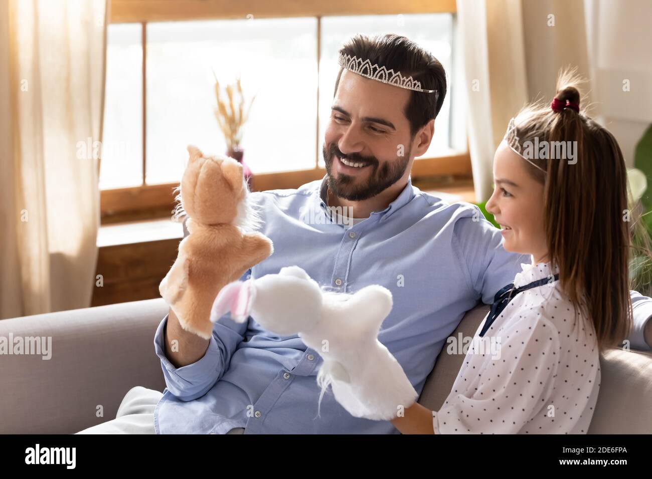 Young Caucasian dad have fun play girly game with daughter Stock Photo