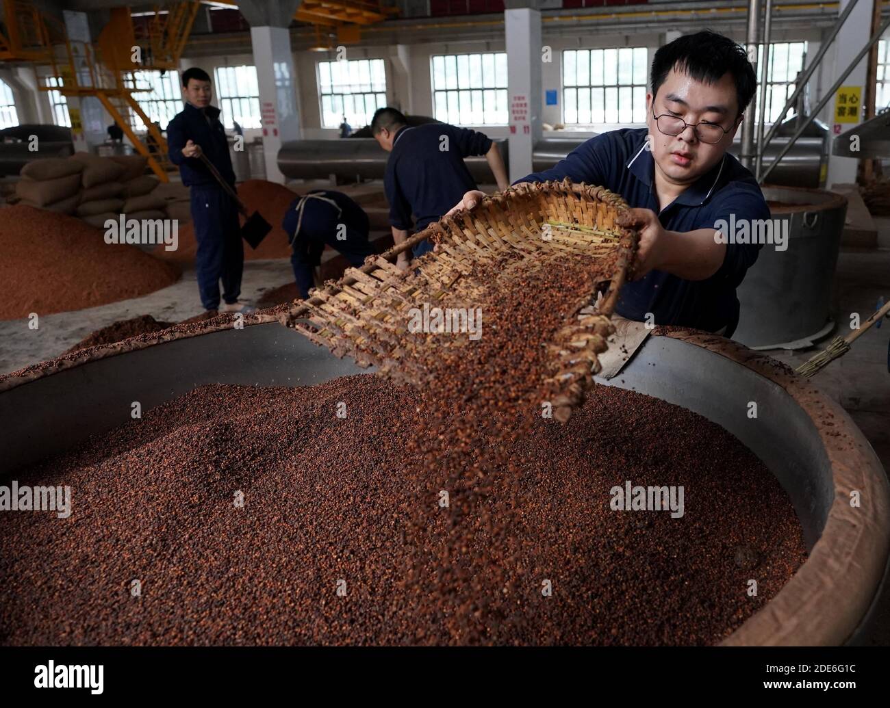 (201129) -- GUIZHOU, Nov. 29, 2020 (Xinhua) -- Hu Meng (R), 26, works at a distillery in Maotai town of Renhuai, southwest China's Guizhou Province, Nov. 28, 2020. Hu graduated from Xihua University in southwestern Chinese city Chengdu and has been working here since this September. Maotai is a small town in Renhuai City in mountainous Guizhou. What distinguishes it from other towns is that it produces a famous brand of Chinese liquor Moutai. The spirit, made from sorghum and wheat, takes up to one year for the whole production process, involving nine times of steaming, eight times of ferment Stock Photo