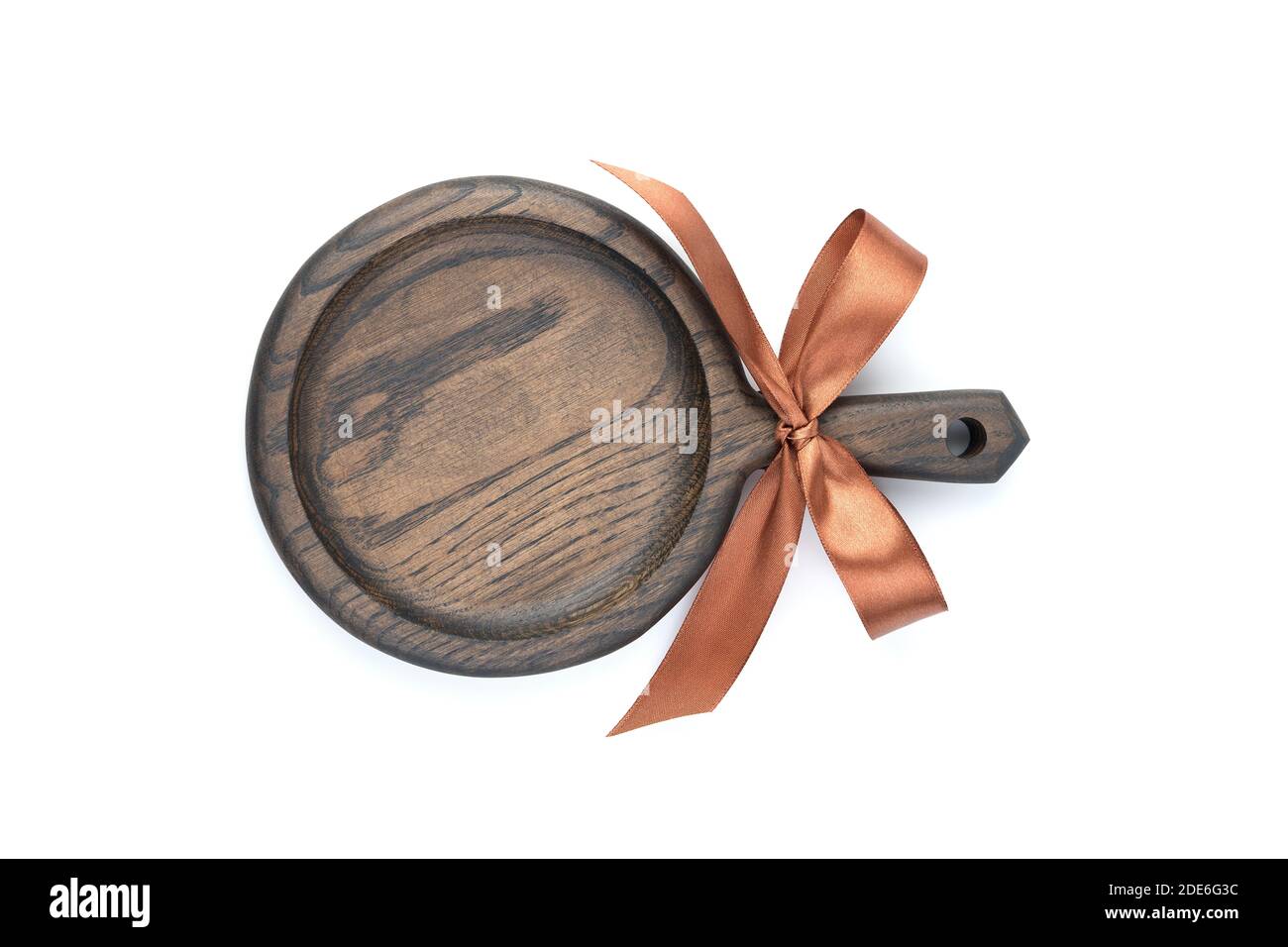 A cutting Board with a gift bow, painted in a dark color, is isolated on a white background. Stock Photo