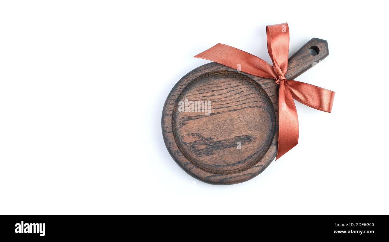 Cooking background with cutting Board with gift bow on white background Stock Photo