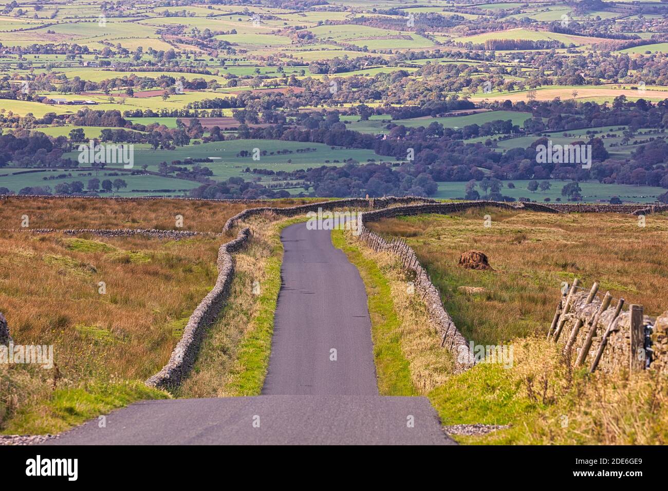 View looking down a Country Road near Staimore with the Eden Valley in the distance, Cumbria, England, UK. Stock Photo