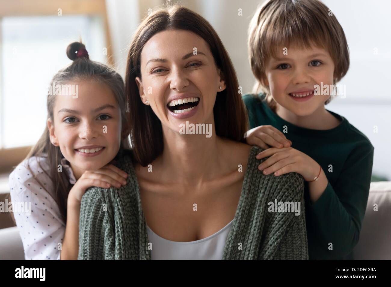 Portrait of smiling mom have fun relax with kids Stock Photo