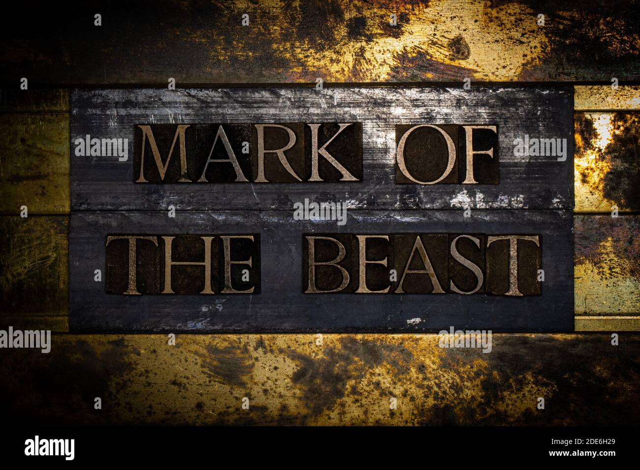 Mark Of The Beast text on textured grunge copper and vintage gold background Stock Photo