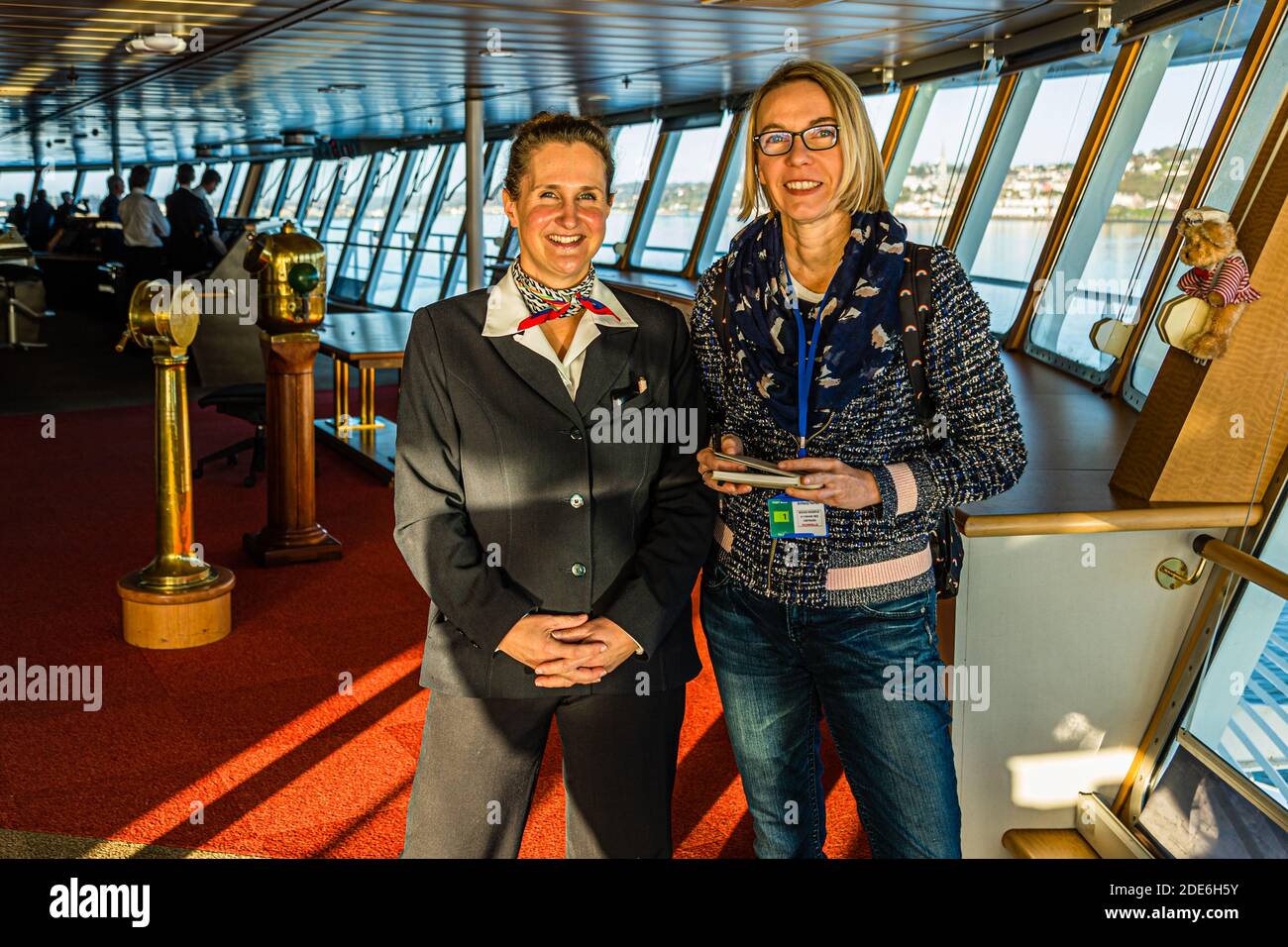 On the bridge of the Pont Aven ferry at the entrance to the port of Cork in Ireland. Entertainment manager Julie Moranges answers questions from journalist Angela Berg on the bridge Stock Photo