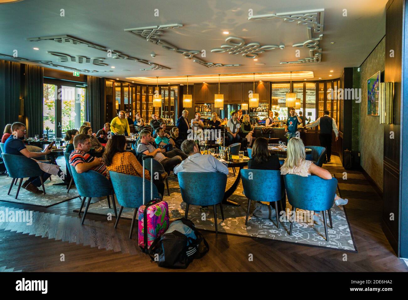 Guests sit in the bar of the five-star Dunloe Hotel & Gardens near Killarney, County Kerry, Ireland, as a match of the Irish rugby team at the World Cup in Japan is broadcast there. Ireland won the pool match against Samoa 47-5 on this day, 12 October 2019. Stock Photo