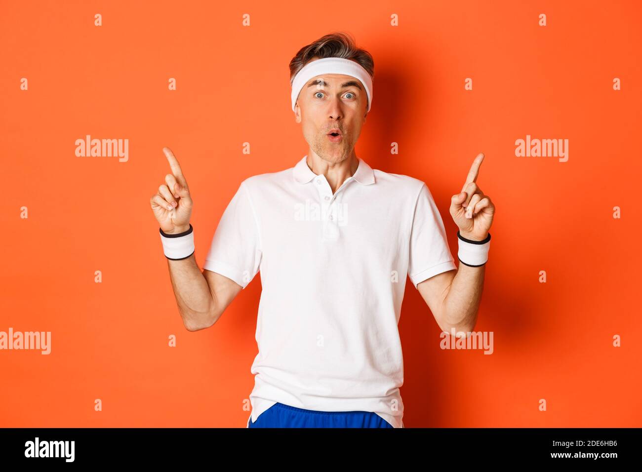 portrait-of-handsome-middle-aged-guy-in-sports-clothing-pointing