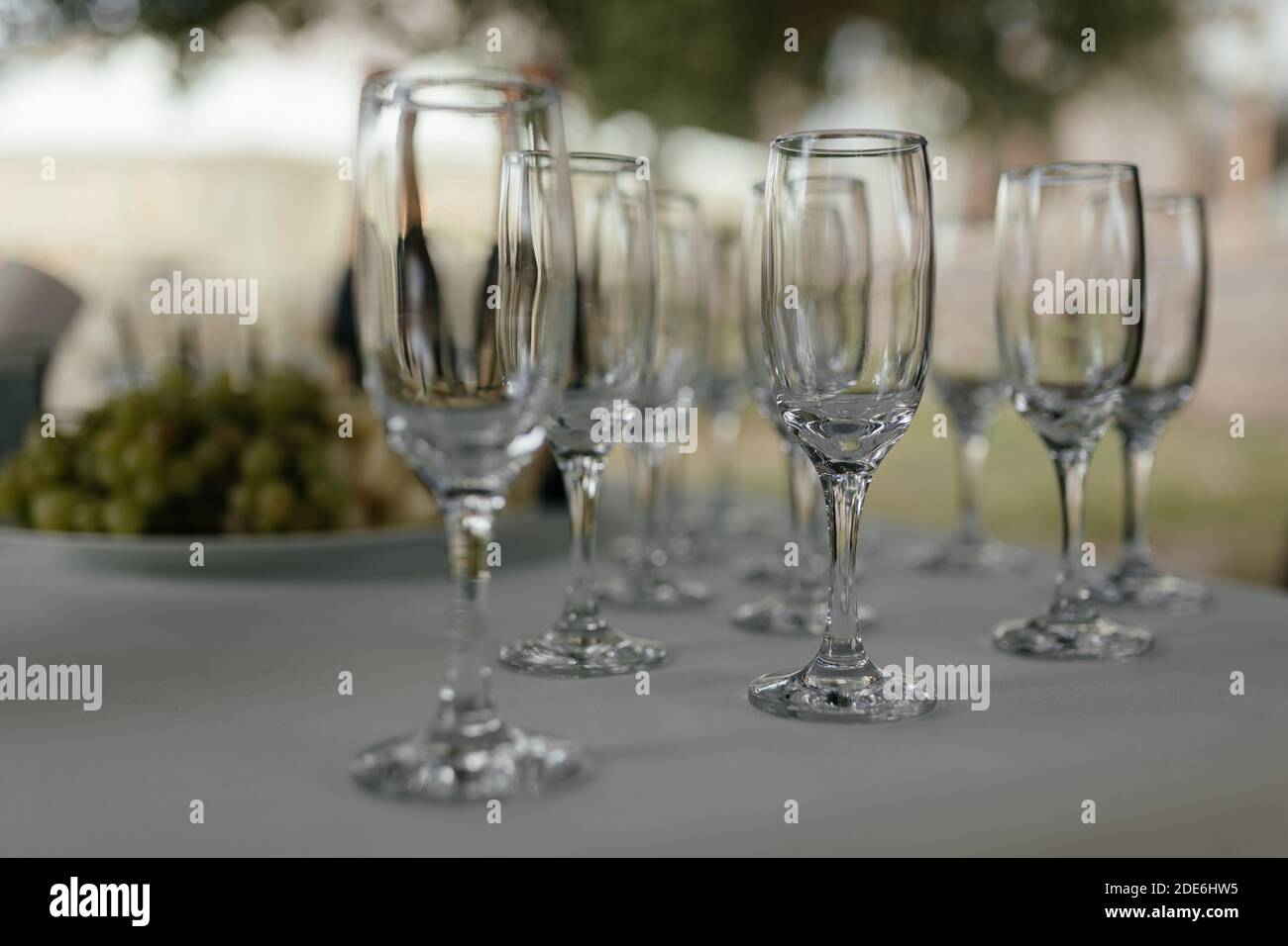 Empty champagne glasses at the white table with the place for your text. Wine glass. Alcohol party Stock Photo