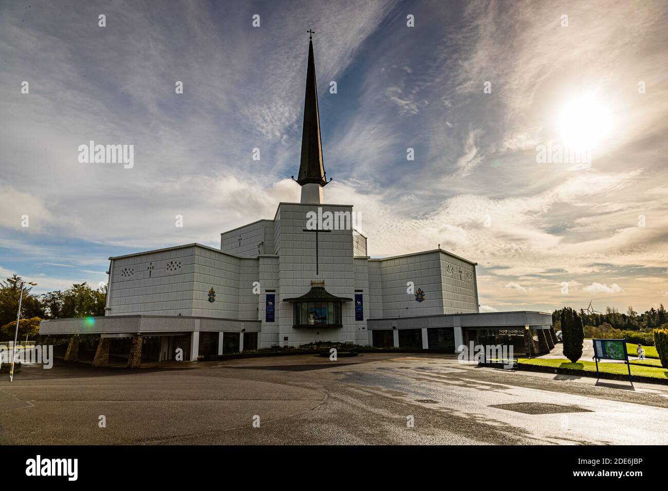 The Basilica of Our Lady, Queen of Ireland, rises with its slender spire above the Knock Shrine Marian pilgrimage site in County Mayo, Ireland. Pope Paul VI blessed the foundation stone in 1974, and Pope John Paul II elevated the church to a basilica in 1979 to mark the apparition's centenary. Stock Photo