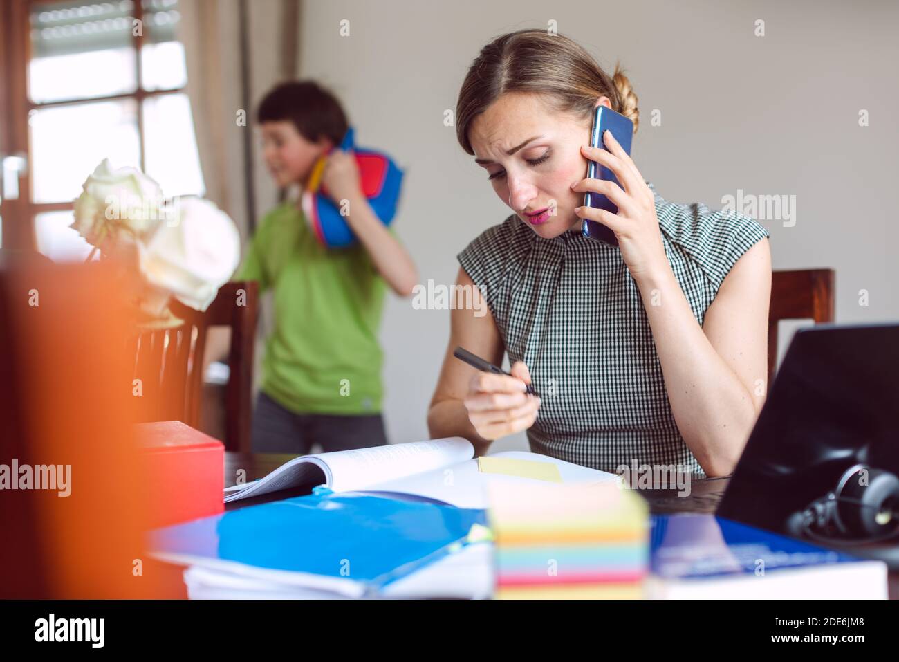 Stressed Businesswoman forced to work from home during lockdown Stock Photo