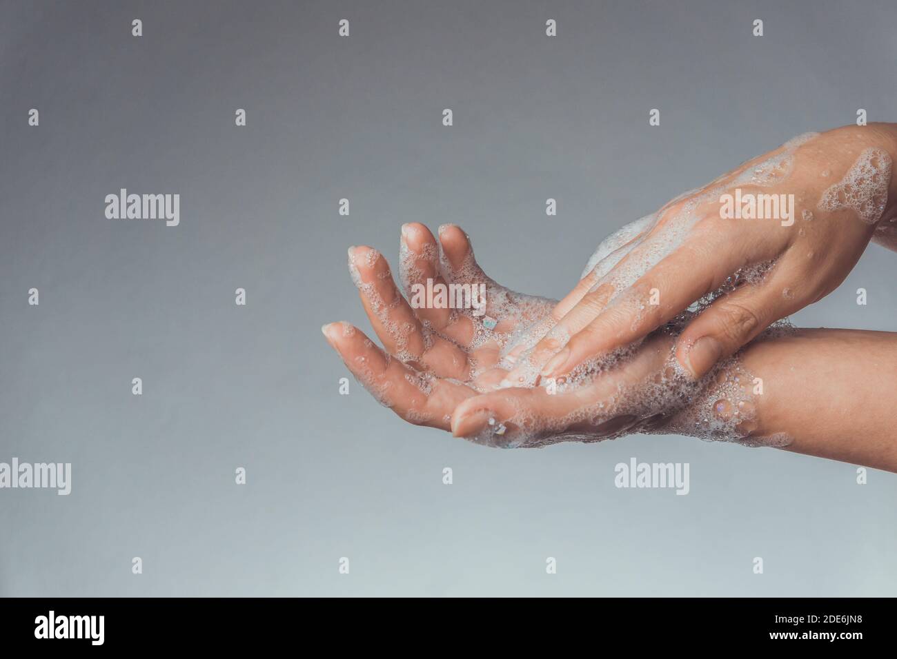 Woman washing and rubbing hands with soap for corona virus prevention; hygiene to stop spreading coronavirus. Stock Photo