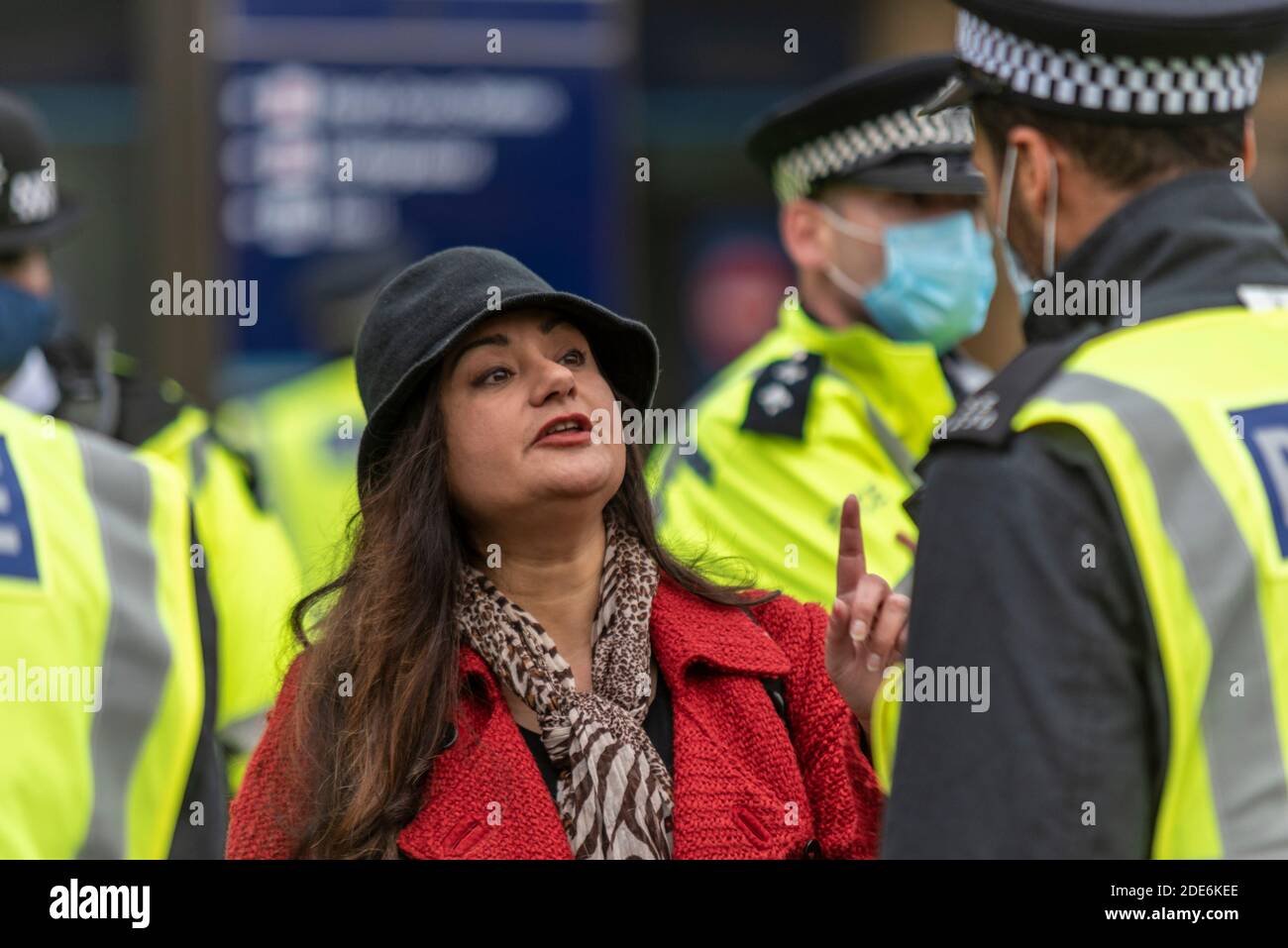 Well dressed white Caucasian female arguing with police at a COVID 19 Coronavirus anti lockdown protest march in London, UK Stock Photo
