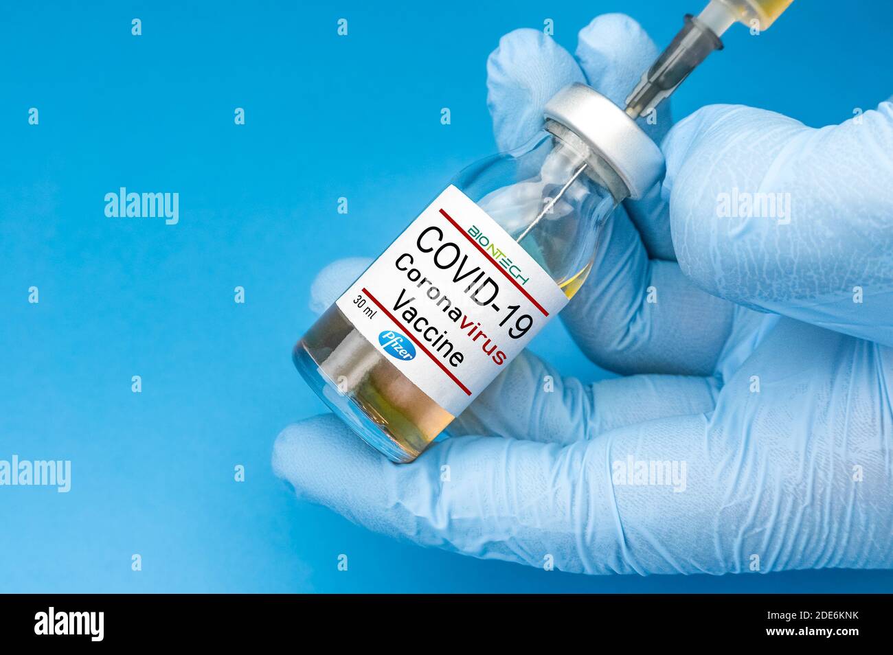 Izmir, Turkey - January 17 2021: Coronavirus vaccine concept and background. New vaccine pfizer and biontech isolated on blue background. Covid-19 Stock Photo