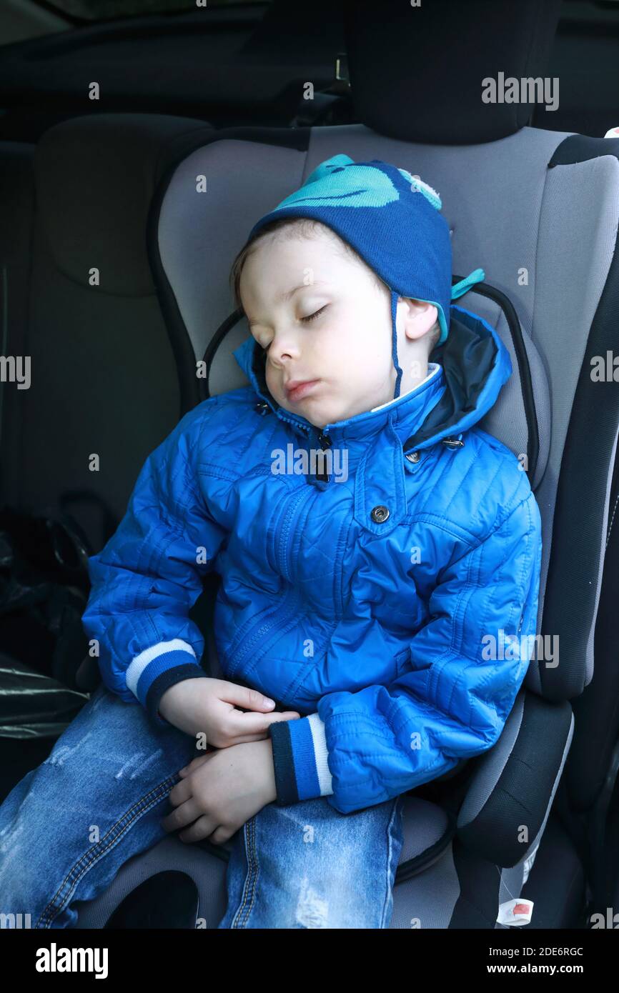 Portrait of child sleeping in car seat Stock Photo Alamy