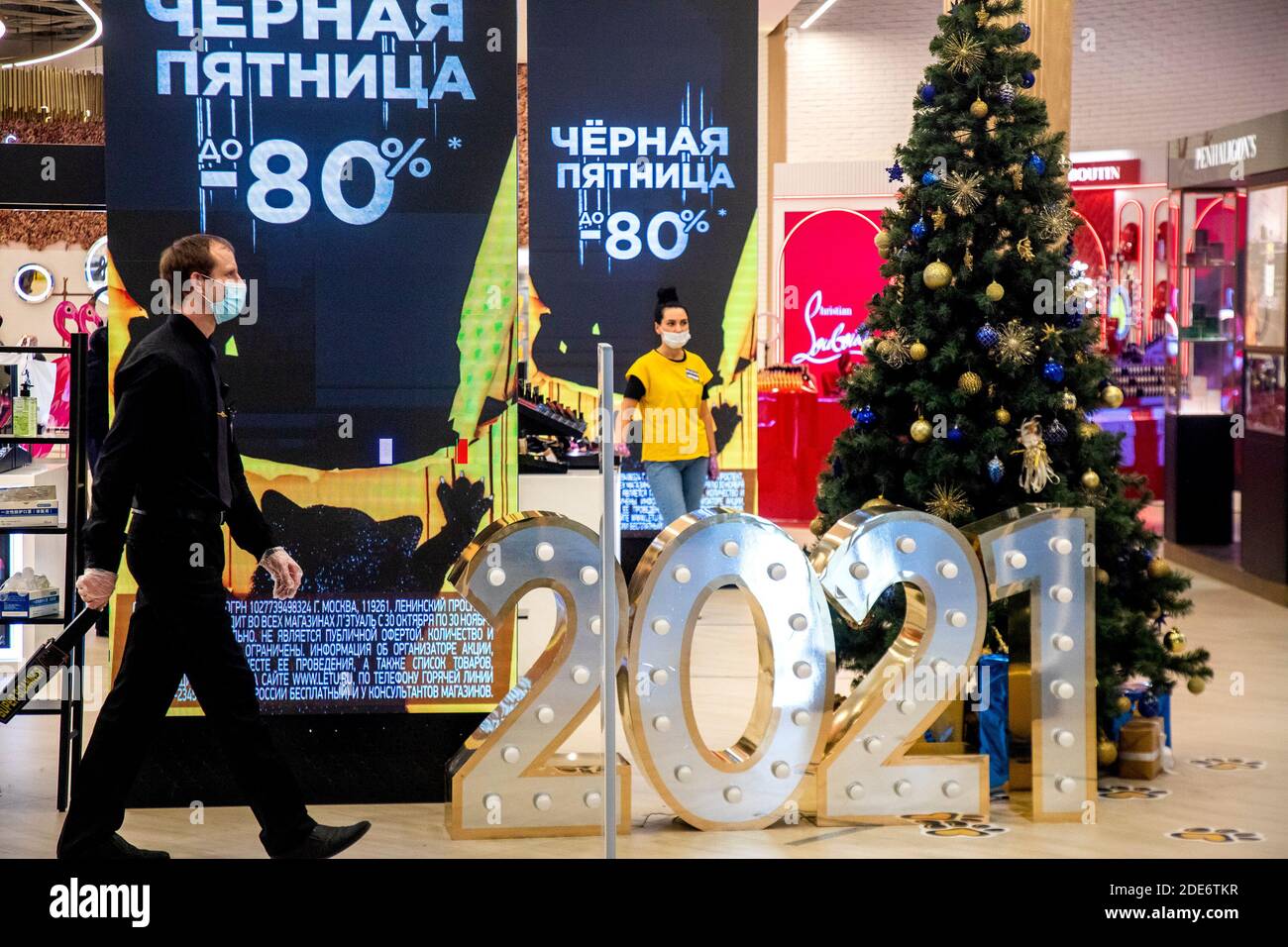 Moscow, Russia. 29th of November, 2020 employees perfume shop wearing face mask in the Aviapark shopping mall on the Black Friday sales days during the novel coronavirus COVID-19 pandemic in Russia. The posters read "Black Friday". The term Black Friday was coined in the United States in the 1960s; it refers to the Friday following Thanksgiving Day celebrated in the US on the fourth Thursday of November. Being the biggest shopping event of the year, Black Friday opens the Christmas shopping season Stock Photo