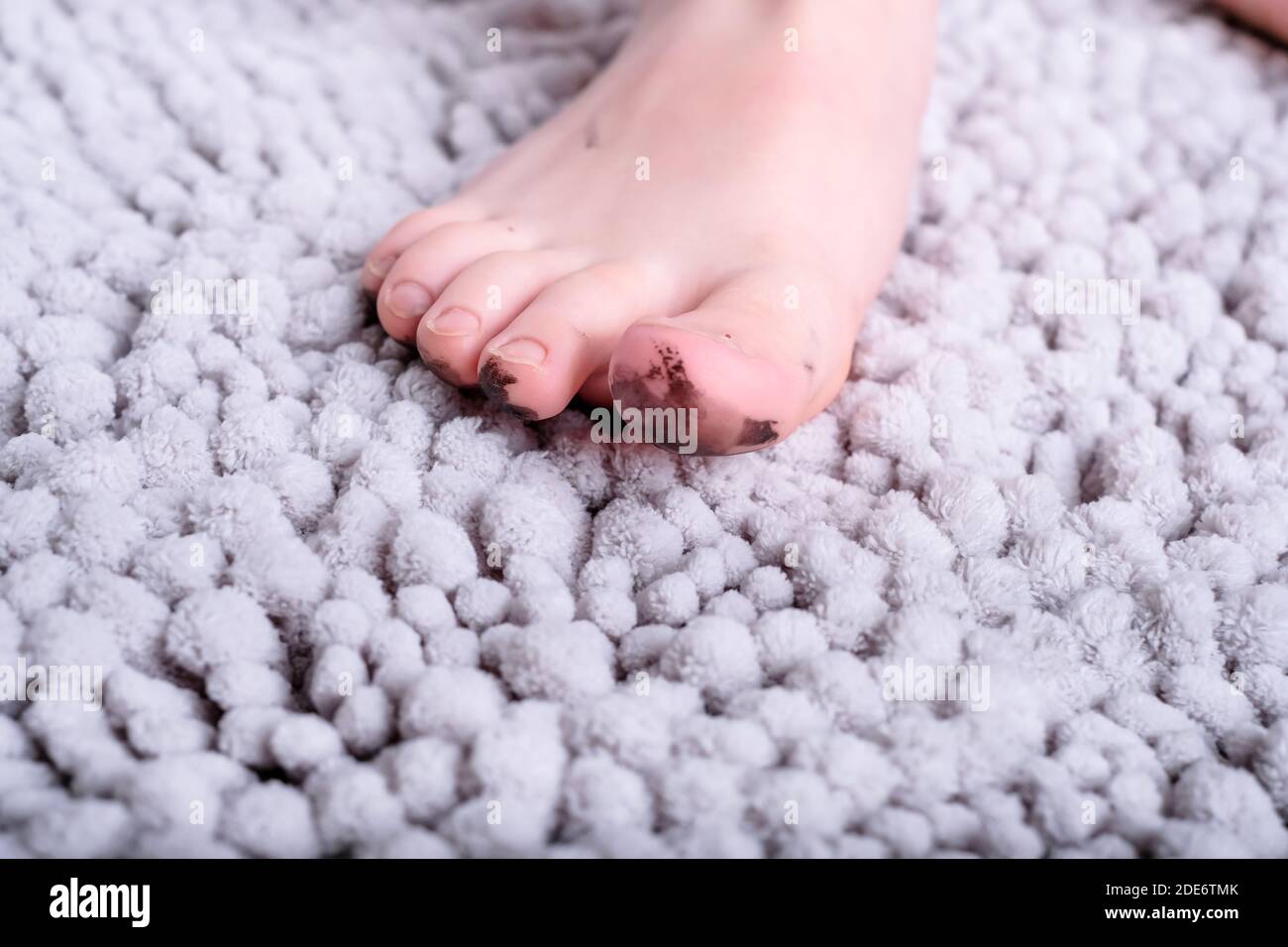 Close up of dirty barefoot of child on mat. place for text. High quality photo Stock Photo