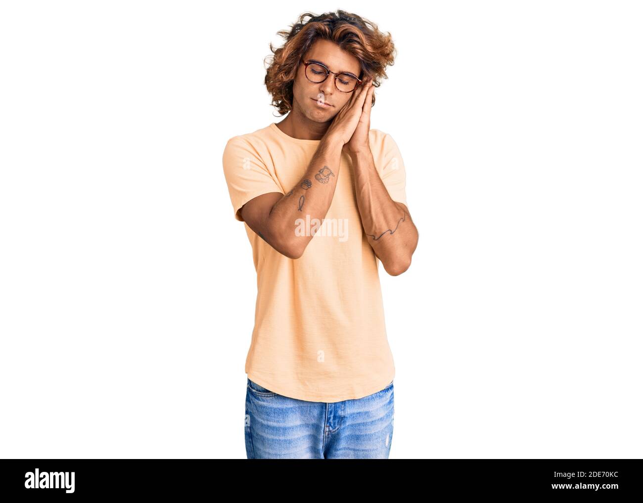 Young hispanic man wearing casual clothes and glasses sleeping tired ...