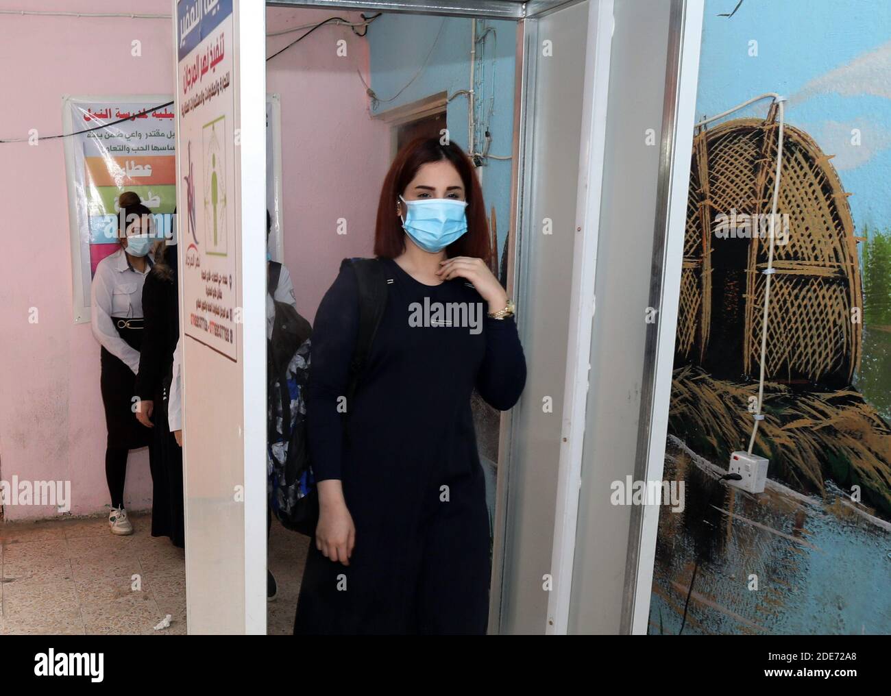 Baghdad. 29th Nov, 2020. Students go through disinfection procedures before entering classrooms at a school in Baghdad, Iraq, on Nov. 29, 2020. The Iraqi Health Ministry reported on Sunday 1,614 new COVID-19 cases, bringing the nationwide infections to 550,435. New school year has started across Iraq on Nov. 29. Credit: Xinhua/Alamy Live News Stock Photo