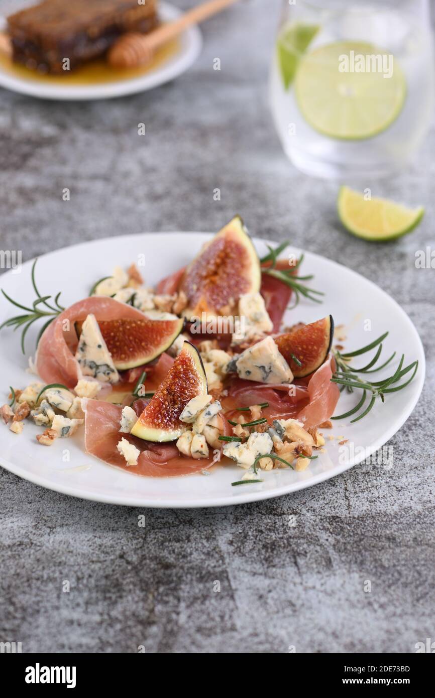 Figs with Parma ham with blue cheese, nuts and honey Stock Photo Alamy