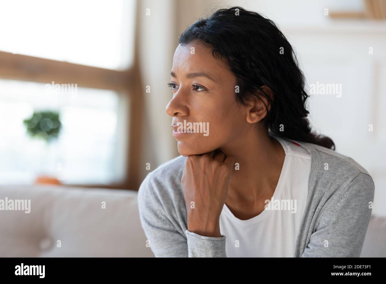 Pensive African American woman look in distance dreaming Stock Photo ...