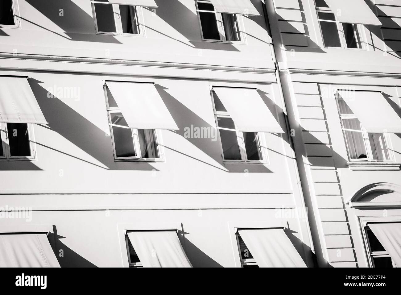 White windows with shutters, black and white photo. Windows pattern